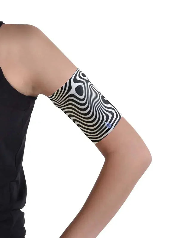 Blood glucose monitor armband with black and white pattern for protecting glucose sensors.