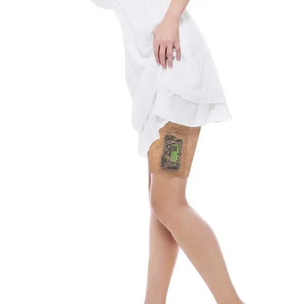 Woman wearing a Dia-Lacy lace garter on thigh securely holding an insulin pump under a white dress