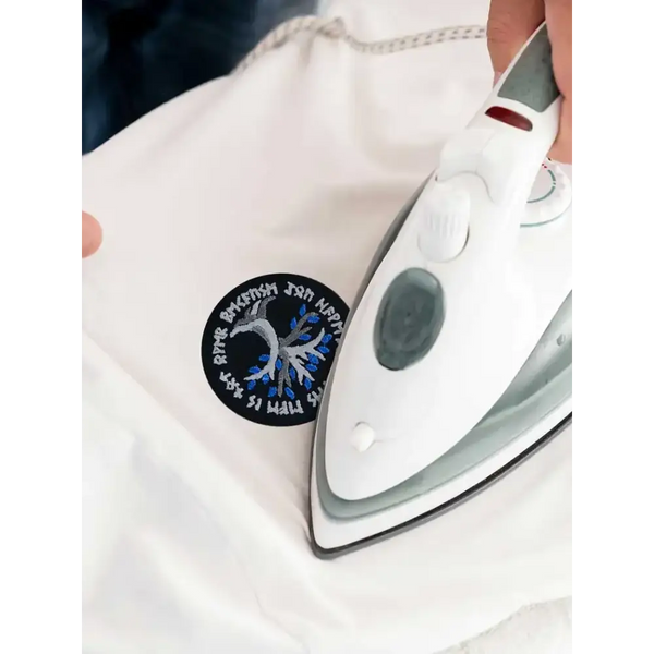 Viking-inspired embroidered diabetes awareness iron-on patch being applied to fabric.