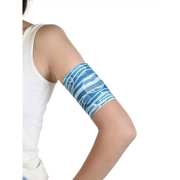 Glucose sensor armband for kids with beach and sea print, secure fit on child's arm.