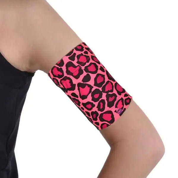 Fluorescent Dia-Band armband for insulin patch pump and sensor, pink leopard design worn on arm.
