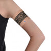 Narrow diabetic sensor armband on upper arm with decorative print.