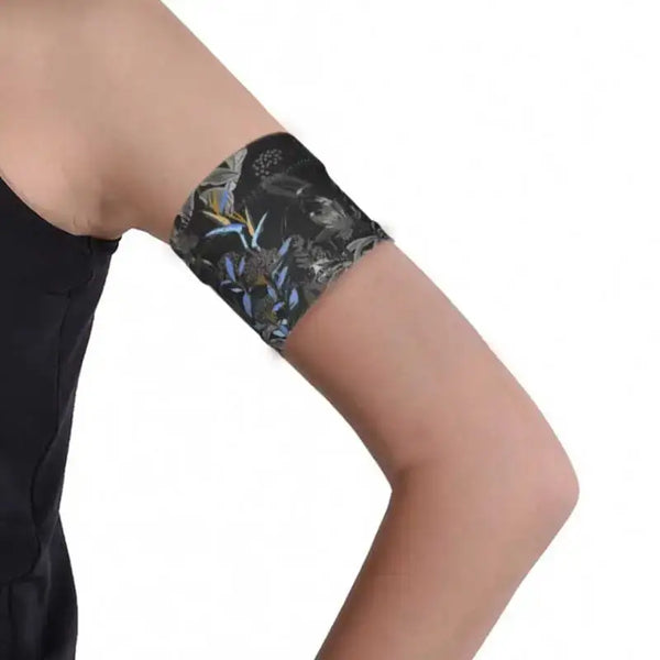 Narrow Diabetic Sensor Armband on upper arm, breathable fabric, secure for glucose sensors, ideal for sports or swimming.