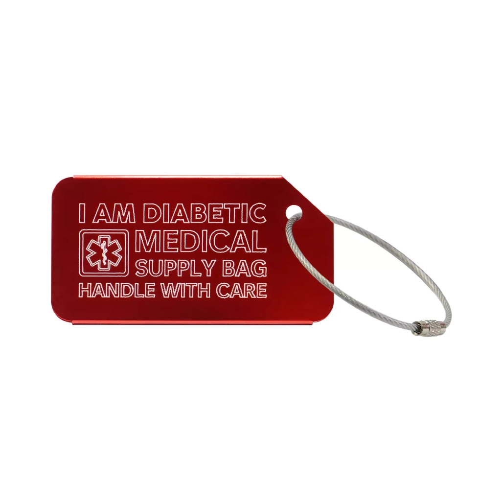 Red medical luggage tag with the text 'I Am Diabetic Medical Supply Bag Handle With Care' engraved. Image