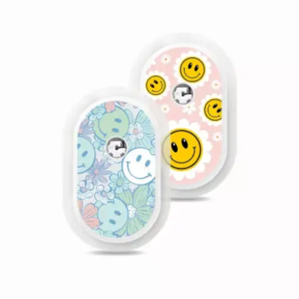 Sibionics GS1 CGM devices with colorful vinyl stickers, featuring smiley faces and floral designs. Image