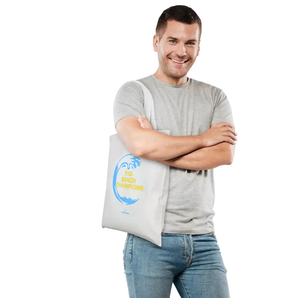 Diabetes awareness bag with T1D Beach Champions design from Kaio-Tote Summer 2024, modeled by a person standing with crossed arms.