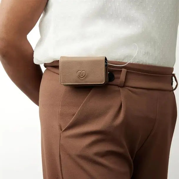 Leather insulin pump holder attached to trousers, showcasing secure and stylish MED KEEPER design.