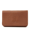 Leather insulin pump holder with a sealable flap and magnetic closure for diabetes management.