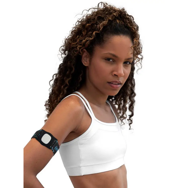 White sports bra with Medtronic Simplera CGM fitness tracker on upper arm