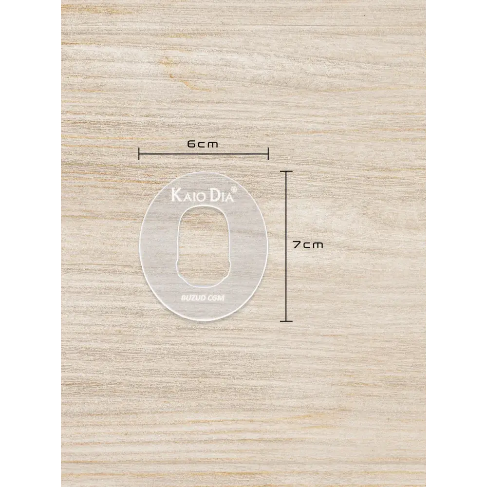 CGM sensor patch template for precise patch cutting on wooden surface.