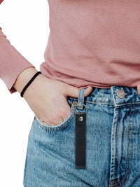 Diabetes T1 leather keychain attached to denim jeans, promoting diabetes awareness.