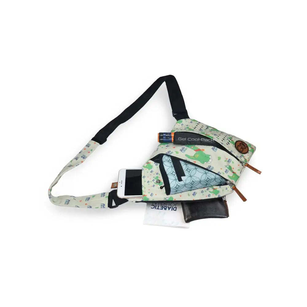Shoulder bag with cooling system for children, designed for active diabetics, featuring space for insulin pens, glucose meter, and personal items, with adjustable strap and fun printed fabric.
